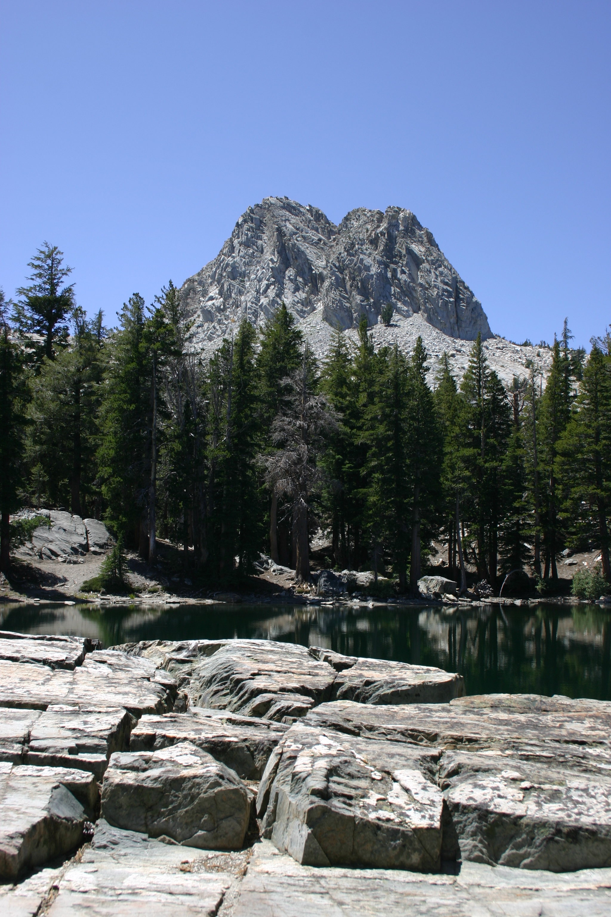 Crystal Crag and broken rocks face off at TJ Lake or Lake Barrett (not sure which). 