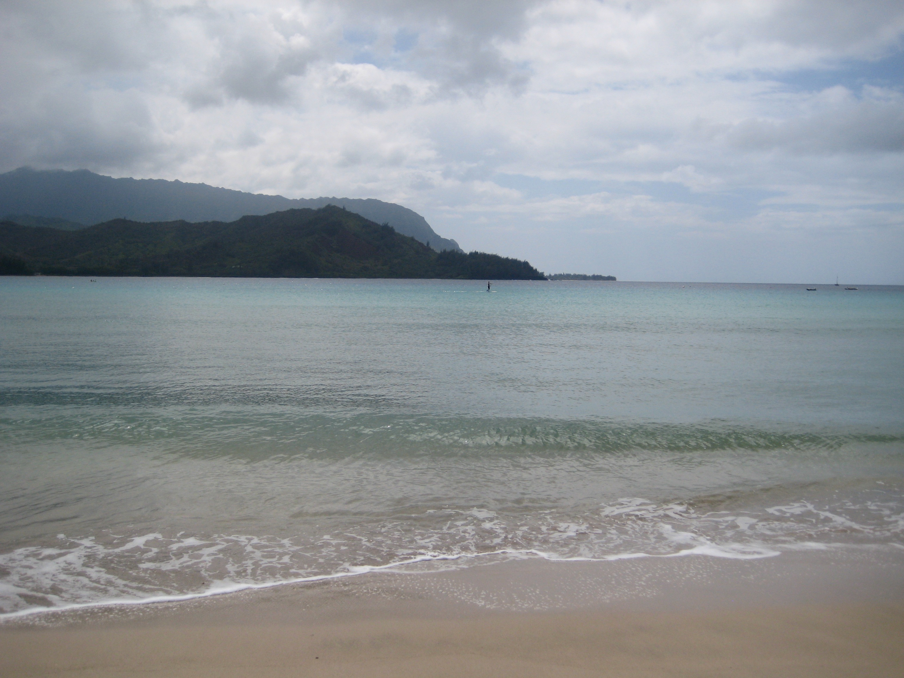 Gentle waves lap the shore at Hanalei Bay. 