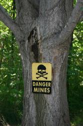 Yellow and black warning sign with a skull and crossbones that says, 