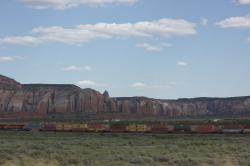 A colorful train rolls through the Arizona landscape near the New Mexico border.